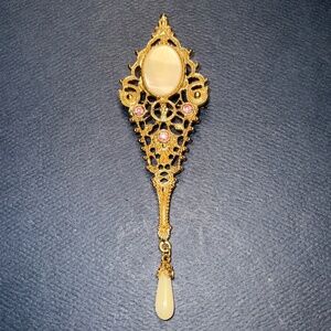 Minor shaped 1938 brooch w/ pink rhinestone accents & oval cabochon stone